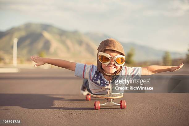 junge fliegen auf skateboard präsentiert - fliegerbrille stock-fotos und bilder