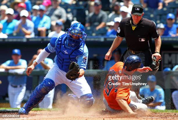 Robbie Grossman of the Houston Astros slides safely into home as catcher Brett Hayes of the Kansas City Royals is late applying the tag during the...