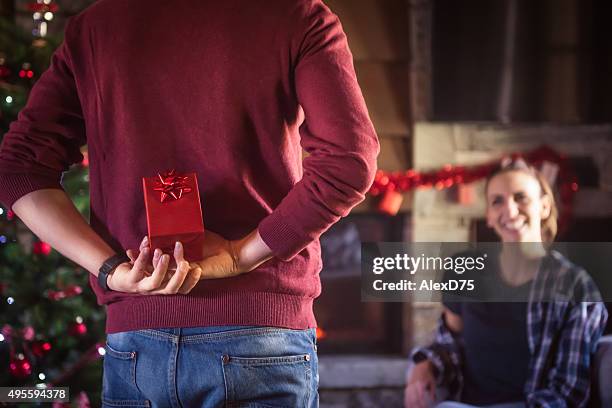 man giving present to girlfriend - hiding behind back stock pictures, royalty-free photos & images