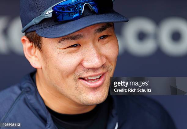 Masahiro Tanaka of the New York Yankees looks on from the dugout before the start of their game against of the Oakland Athletics at Yankee Stadium on...