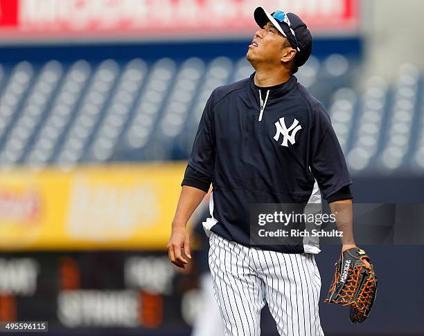 Hiroki Kuroda of the New York Yankees looks up during warm ups before the start of their game against of the Oakland Athletics at Yankee Stadium on...