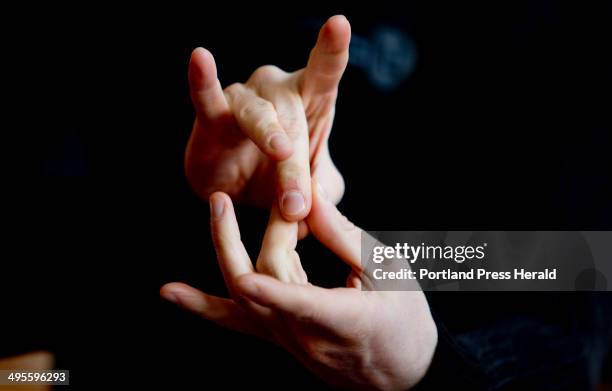 Garrett Zuercher of Wisconsin, the lead actor in Tribes, uses American Sign Language while conducting an interview with a reporter at Portland Stage...