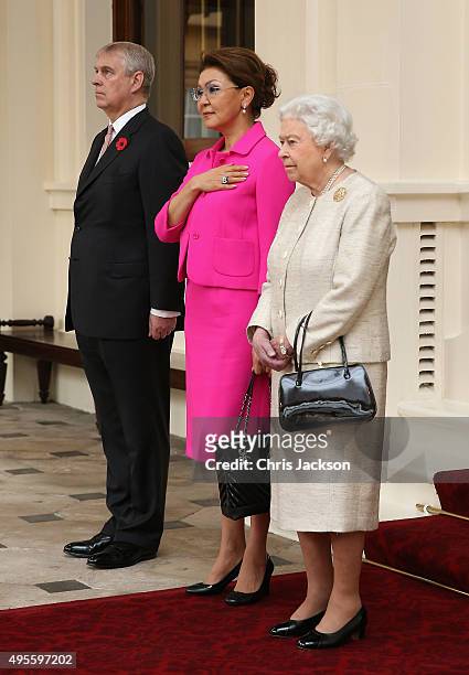 Queen Elizabeth II accompanied by Prince Andrew, Duke of York stands next to Kazakhstan Deputy Prime Minister Dariga Nazarbayeva at Buckingham Palace...