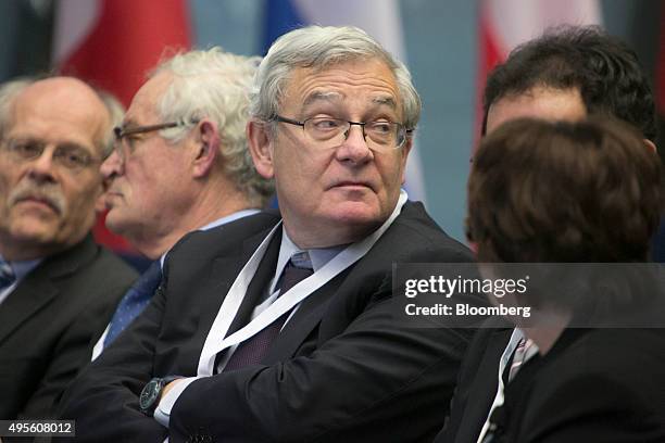 Jean Lemierre, chairman of BNP Paribas SA, center, and Stefan Ingves, governor of the Riskbank, Sweden's central bank, left, sit in the audience...