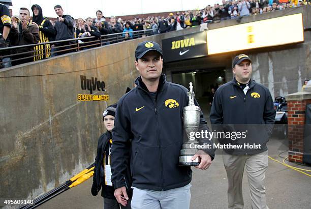 Professional golfer and winner of the British Open Zach Johnson carries the Claret Cup before the Big Ten match-up between the Iowa Hawkeyes and the...