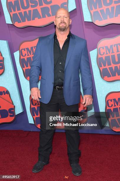 Actor and WWE personality 'Stone Cold' Steve Austin attends the 2014 CMT Music awards at the Bridgestone Arena on June 4, 2014 in Nashville,...