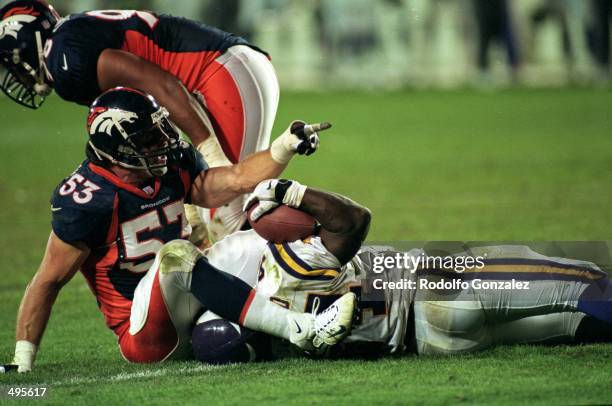 Bill Romanowski of the Denver Broncos makes the tackled during a game against the Minnesota Vikings at the Mile High Stadium in Denver, Colorado. The...