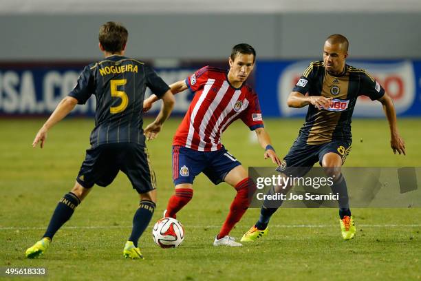 Eric Avila of Chivas USA defends the ball from Fred Da Silva of Philadelphia Union and Vincent Nogueira of Philadelphia Union in the second half at...