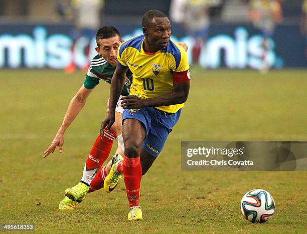 Walter Ayovi of Ecuador looks to pass in front of Hector Herrera of Mexico during an international friendly match at the AT&T Stadium on May 31, 2014...