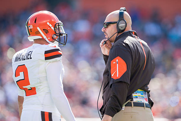 Quarterback Johnny Manziel of the Cleveland Browns talks to head coach Mike Pettine during the first half against the Tennessee Titans at FirstEnergy...