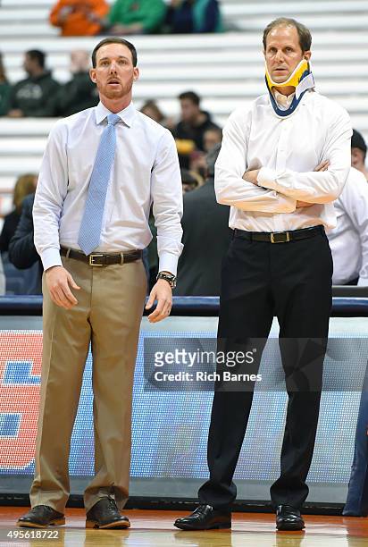Assistant coach Gerry McNamara and assistant head coach Mike Hopkins of the Syracuse Orange look on prior to the game against the Le Moyne Dolphins...