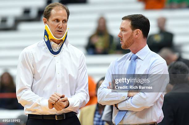 Assistant head coach Mike Hopkins and assistant coach Gerry McNamara of the Syracuse Orange talk prior to the game against the Le Moyne Dolphins at...
