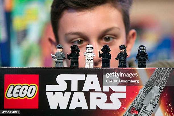 Child looks at Lego figurines from the Star Wars 'Kylo Ren's Command Shuttle', manufactured by Lego A/S, as it sits on display at the Toy Retailers...