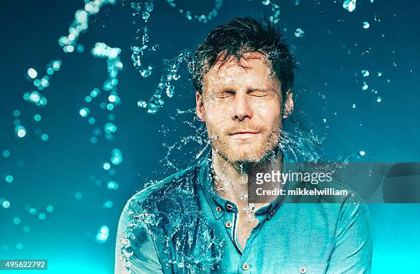 bucket of water hits a man in the head - slow motion water stock pictures, royalty-free photos & images