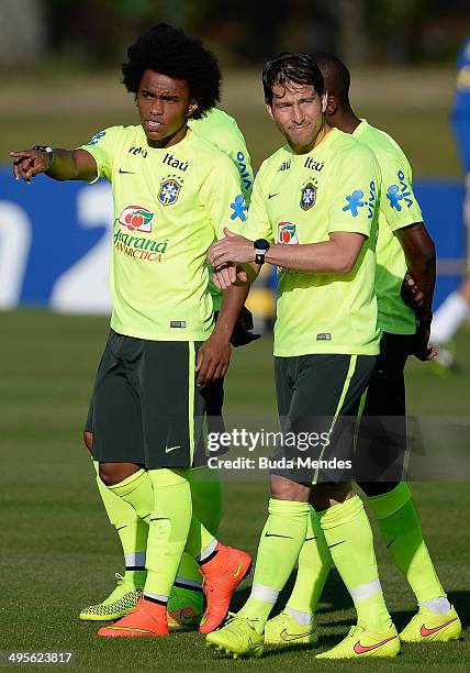 William gestures next to Maxwell during a training session of the Brazilian national football team at the squad's Granja Comary training complex, in...
