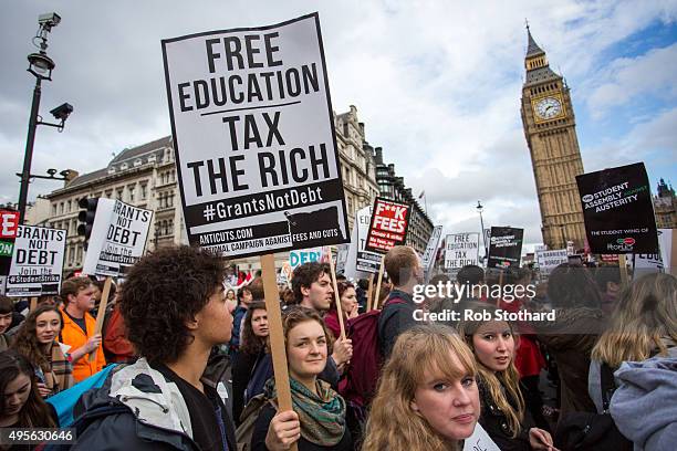 Protestors march past the Houses of Parliament during a protest against education cuts and tuition fees on November 4, 2015 in London, England....