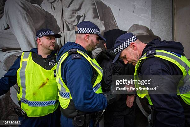 Protestors is detained by police officers during a protest against education cuts and tuition fees on November 4, 2015 in London, England. University...