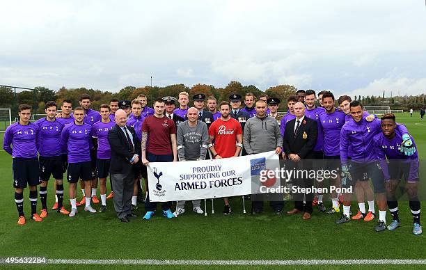 Players of Tottenham Hotspur meet members of the armed forces ahead of a training session at the clubs training ground on November 4, 2015 in...