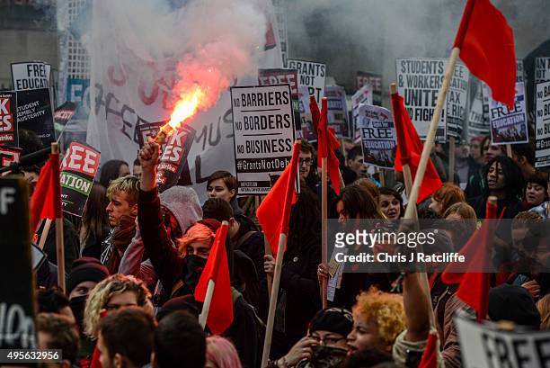 Protesters let off flares during a demonstration against education cuts on November 4, 2015 in London, England. University students from across the...