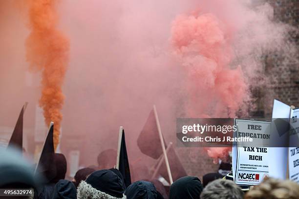 Protesters let off smoke bombs during a demonstration against education cuts on November 4, 2015 in London, England. University students from across...