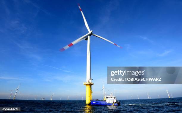 Service vessel picks up workers from a wind turbine of the German offshore wind farm "Amrum Bank West" owned by German energy company E.ON are seen...