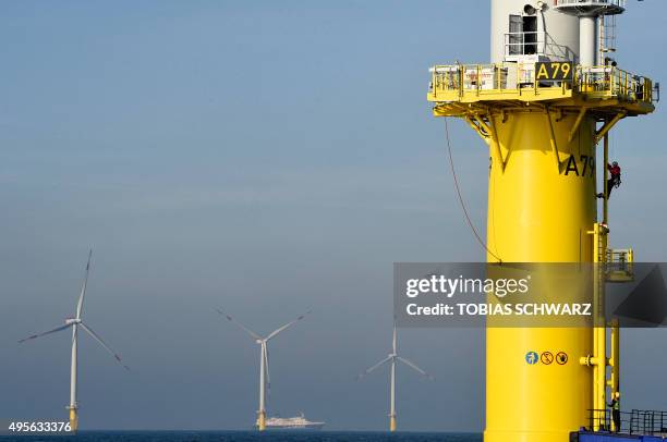 Worker gets off a wind turbine of the German offshore wind farm "Amrum Bank West" owned by German energy company E.ON near the Heligoland archipelago...