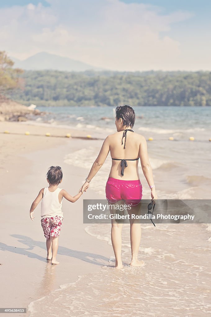 Mother and child walking on the beach