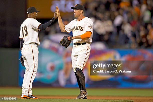 Hunter Pence of the San Francisco Giants celebrates with Joaquin Arias after the game against the Chicago Cubs at AT&T Park on May 27, 2014 in San...