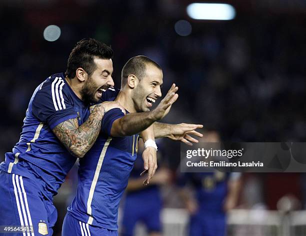 Javier Mascherano of Argentina celebrates with Ezequiel Lavezzi after scoring his team's second goal during a FIFA friendly match between Argentina...