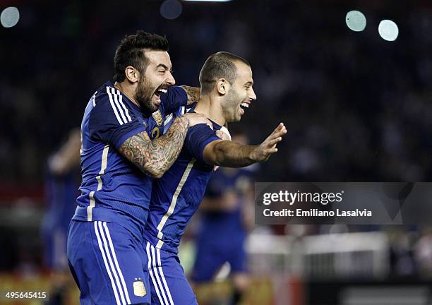 Javier Mascherano of Argentina celebrates with Ezequiel Lavezzi after scoring his team's second goal during a FIFA friendly match between Argentina...