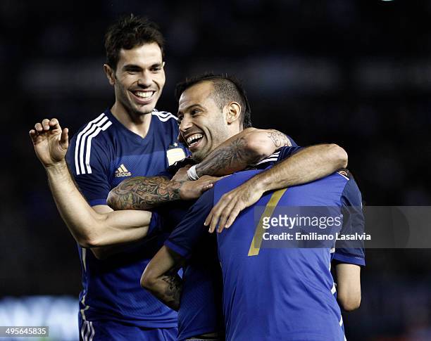 Javier Mascherano of Argentina celebrates with Jos? Basanta and ?ngel Di Mar?a after scoring his team's second goal during a FIFA friendly match...