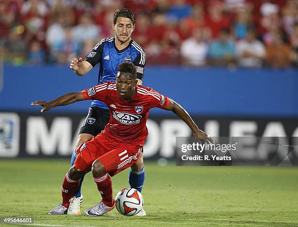 Fabian Castillo of FC Dallas works to regain control of the ball after a bump Jean-Baptiste Pierazzi of San Jose Earthquakes at Toyota Stadium on May...