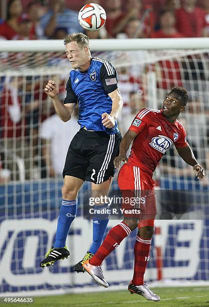 Ty Harden of San Jose Earthquakes heads the ball as Fabian Castillo of FC Dallas looks on at Toyota Stadium on May 31, 2014 in Frisco, Texas.