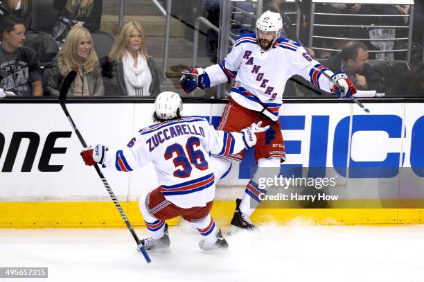 Benoit Pouliot of the New York Rangers celebrates with teammate Mats Zuccarello after Pouliot scores the first goal in the first period against the...