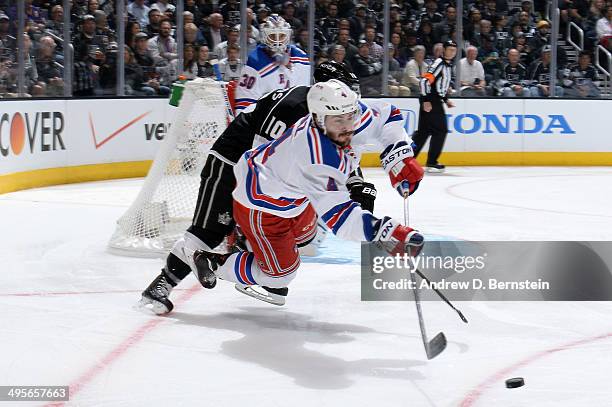 Raphael Diaz of the New York Rangers handles the puck against Mike Richards of the Los Angeles Kings in Game One of the Stanley Cup Final during the...
