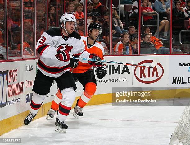 Jiri Tlusty of the New Jersey Devils skates against Nick Schultz of the Philadelphia Flyers on October 29, 2015 at the Wells Fargo Center in...