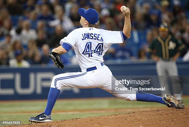 Casey Janssen of the Toronto Blue Jays delivers a pitch in the ninth inning during MLB game action against the Oakland Athletics on May 23, 2014 at...