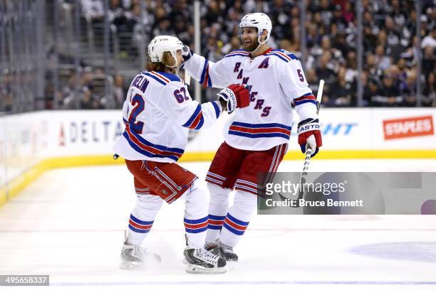 Carl Hagelin of the New York Rangers celebrates with Dan Girardi after scoring a goal in the first period against the Los Angeles Kings during Game...