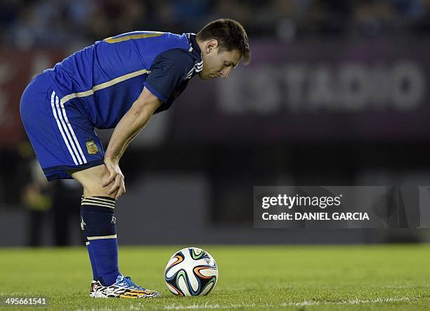 Argentina's forward Lionel Messi observes the ball before taking a free kick during a friendly match against Trinidad and Tobago at the Monumental...