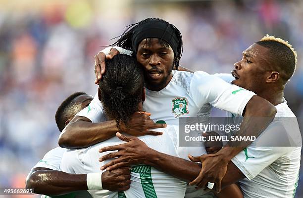 Ivory Coast's forward Gervinho celebrates with teammates after scoring a goal during a World Cup preparation match between Ivory Coast and El...