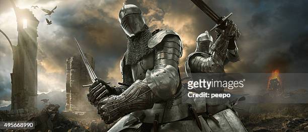 two medieval knights with swords on battlefield near ruined monuments - fältslag bildbanksfoton och bilder