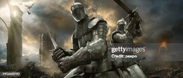 two medieval knights with swords on battlefield near ruined monuments - medieval 個照片及圖片檔