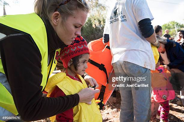 humanitarian volunteer assisting migrants traveling to europe - human trafficking bildbanksfoton och bilder