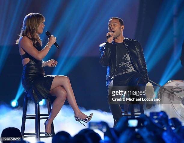 Jennifer Nettles and John Legend perform onstage at the 2014 CMT Music Awards at Bridgestone Arena on June 4, 2014 in Nashville, Tennessee.