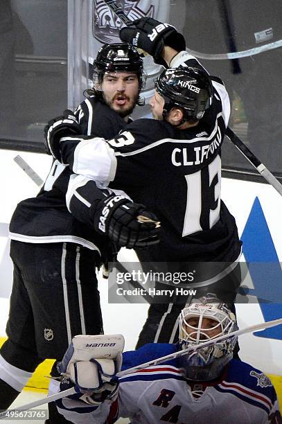 Drew Doughty of the Los Angeles Kings celebrates with Kyle Clifford after scoring a goal against Henrik Lundqvist of the New York Rangers to tie the...