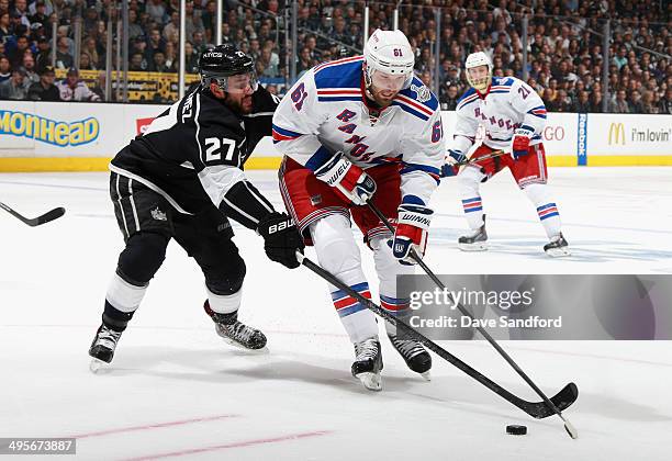 Alec Martinez of the Los Angeles Kings challenges Rick Nash of the New York Rangers during the second period of Game One of the 2014 Stanley Cup...