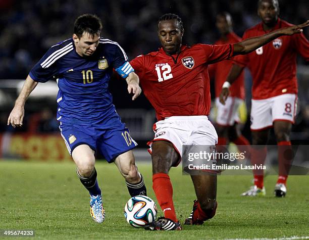 Lionel Messi of Argentina fights for the ball against Yohance Marshall of Trinidad and Tobago during a FIFA friendly match between Argentina and...