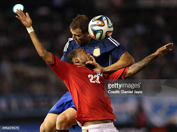 Hugo Campagnaro of Argentina and Lester Peltier of Trinidad and Tobago go for a header during a FIFA friendly match between Argentina and Trinidad &...