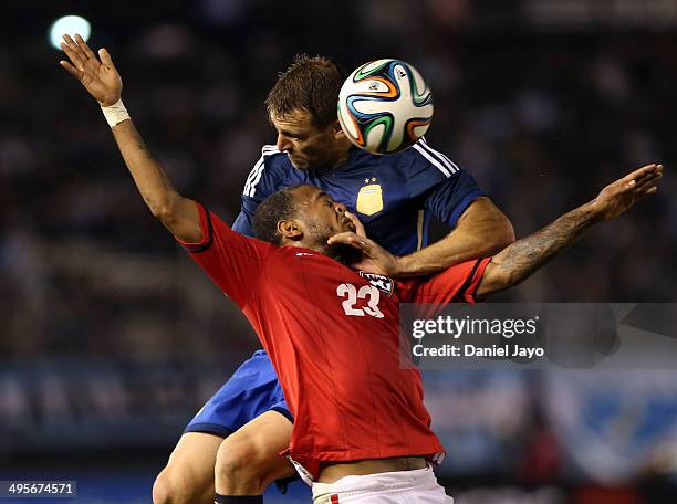 Hugo Campagnaro of Argentina and Lester Peltier of Trinidad and Tobago go for a header during a FIFA friendly match between Argentina and Trinidad &...