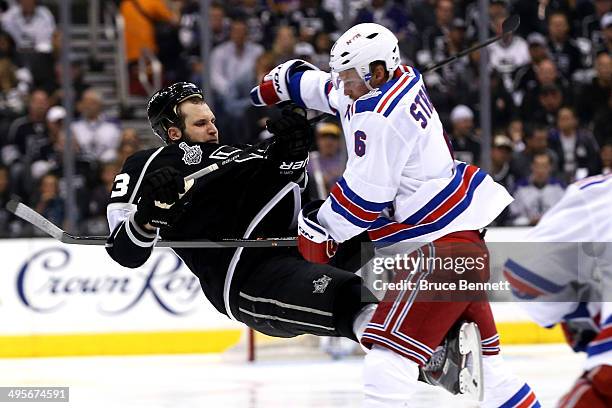 Anton Stralman of the New York Rangers checks Kyle Clifford of the Los Angeles Kings in the second period during Game One of the 2014 NHL Stanley Cup...